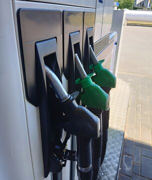Close up of gas station pump nozzles. Fueling car, petrol price and gasoline retail concept. Energy crisis, fuel retail business and high oil prices concept.