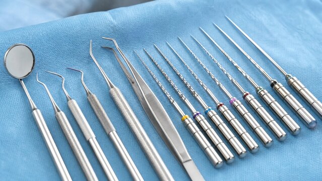 reamers. Stainless steel dental instruments arranged on a blue cloth. safety posters, maintenance manuals, designed for precision metalworking and fabrication facilities.