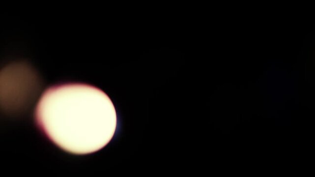 Real Cinematic Lens Flare Overlay on Black Background at 1000fps Slow Motion.