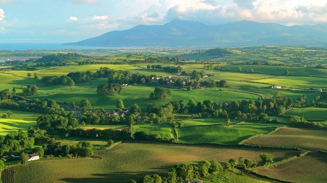 Aerial view of rolling hills and Mourne Mountains during sunset county Down Northern Ireland