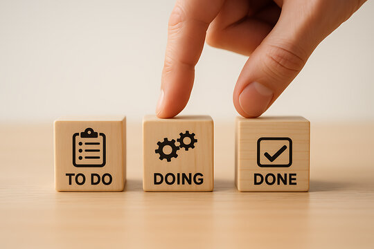 Visualizing project management stages with wooden blocks depicting to do doing and done