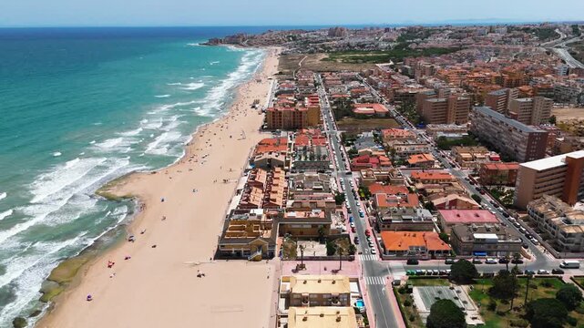Aerial view La Mata town with sandy beach, Mediterranean Sea along coastline. Coastal tourism, summer holiday. Costa Blanca, Torrevieja, Alicante province, Spain