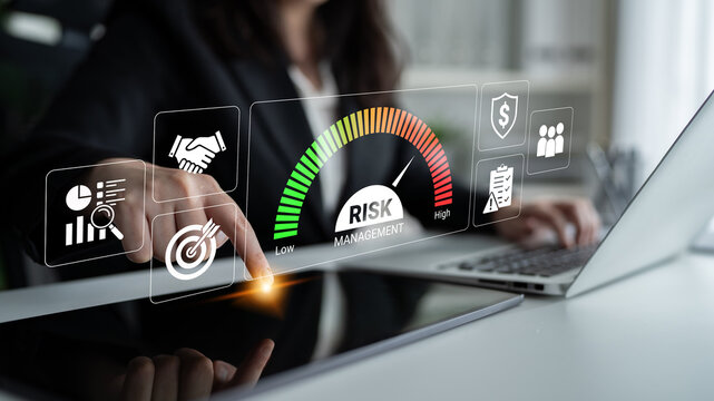 Business professional analyzing risk management metrics with digital interface showing levels of risk and business icons in modern office environment. Glyphic.