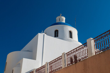 Traditional Cycladic chapel dome under clear blue sky, Santorini, Greece. © Andrei Tomas