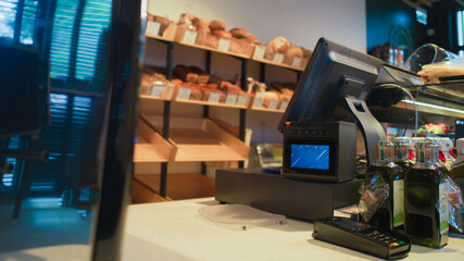 Fototapeta premium Interior of a small cafe with a pastry section. Cash register