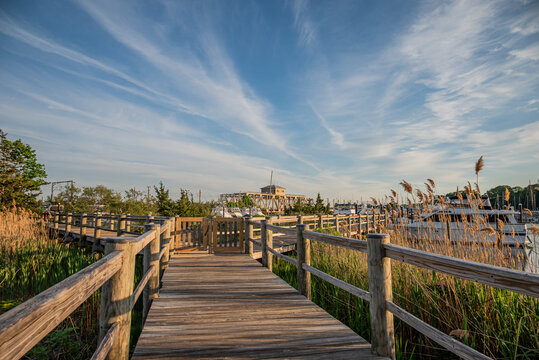 Mystic, Connecticut, USA - Wide Boardwalk View With Dramatic Sky Over Mystic River