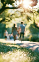 Fototapeta premium blurry image of a couple holding hands and walking in a sunny park with green trees