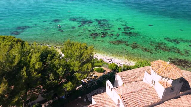 Monte Conero Marche Italy beaches. Santa Maria di Portonovo Aerial Drone footage of Ancient Romanesque Church Surrounded by Lush Green Pine Trees Scenic Turquoise Adriatic Sea Coastline