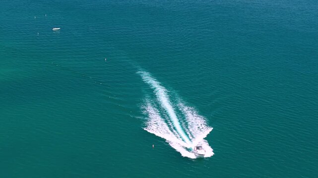 Sirolo Italy 4k drone 70mm luxury travel speed boat action movie rental boats. High end lifestyle video of fast motorboat at isolated tropical turquoise sea Two Sisters beach Due Sorelle faraglioni 