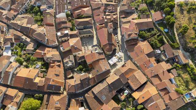 Aerial view of the historic town center of Allariz with dense terracotta-tiled rooftops, narrow stone streets, and ancient architecture in Allariz, Province of Ourense, Spain.