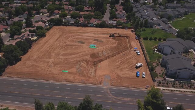 Panning Aerial Drone Shot Right to Left Over Active Construction Site With Workers Pipeline and Heavy Machinery