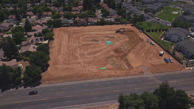 Reversing Aerial Drone Shot Over Active Construction Site With Workers PVC Pipeline and Heavy Machinery