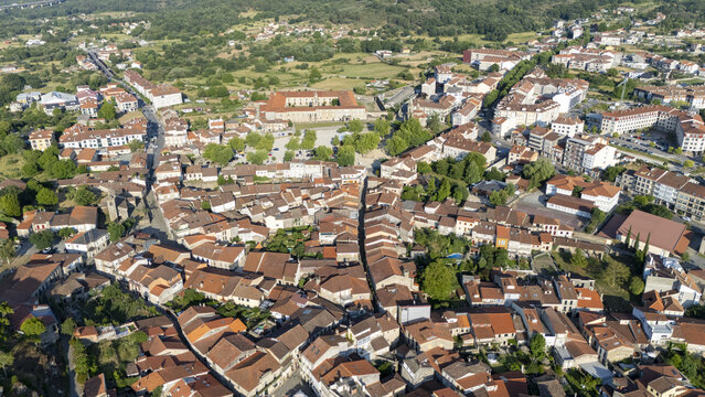 Aerial view of the historic town of Allariz with its dense cluster of terracotta rooftops, narrow streets, and surrounding lush green landscape in Allariz, Province of Ourense, Spain.