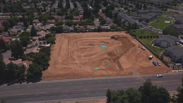 Still Aerial Drone Shot Over Active Construction Site With Workers PVC Pipeline and Heavy Machinery