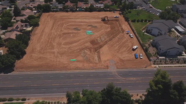 Panning Aerial Drone Shot Left to Right Over Active Construction Site With Workers Pipeline and Heavy Machinery