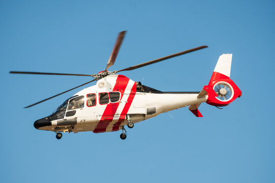 Red and White Emergency Helicopter Airborne in Clear Blue Sky, The Concept of Medical Evacuation
