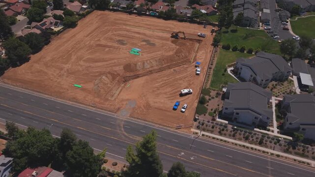 Aerial Drone Shot Over Active Construction Site With Workers PVC Pipeline and Heavy Machinery