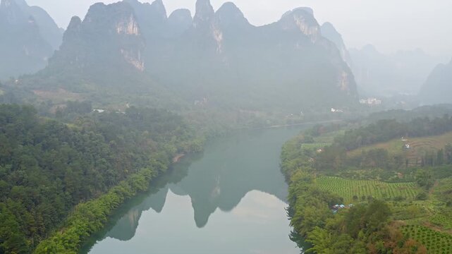 Aerial shot of the amazing Karst Mountains and the Li River in China on a hazy day.