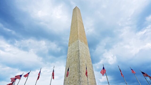 American flags frame the Washington Monument. Patriotic landmark on the National Mall. United States symbol of unity and freedom. Iconic obelisk with waving flags. Washington DC scene.