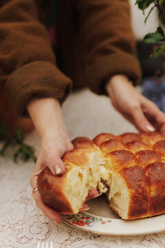 hand breaking bread