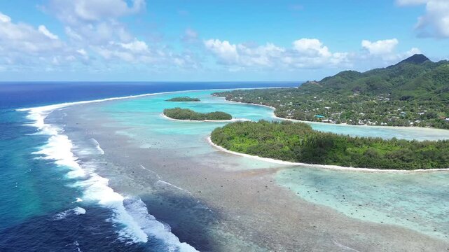 A drone view of Rarotonga,Muri Beach. the capital of the Cook Islands.Beautiful ocean view of coastline with clear water and houses in the sun