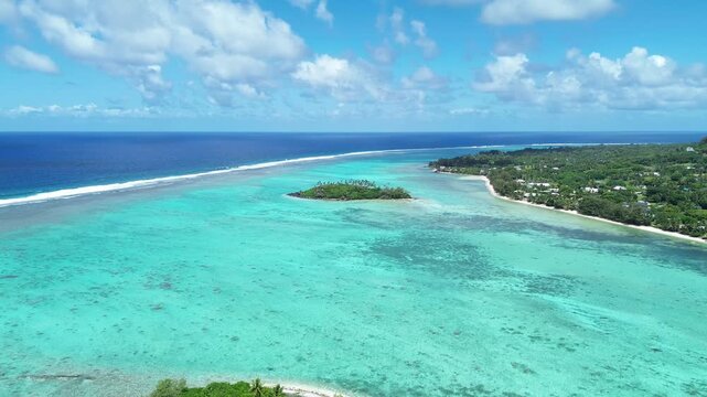 A drone view of Rarotonga,Muri Beach. the capital of the Cook Islands.Beautiful ocean view of coastline with clear water and houses in the sun