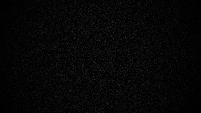 Noise filter television damage effect creates a dark grainy monochrome abstract grit texture. Suitable for design backgrounds and retrothemed projects. 4K overlay
