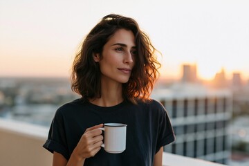 Obraz premium Young woman with a white mug on a balcony at golden hour skyline for lifestyle background and evening routine poster design