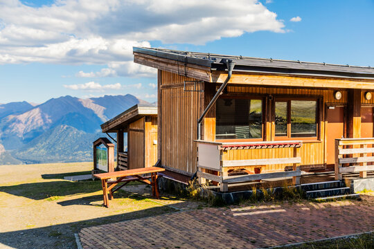 Horizontal wooden mountain lodge with scenic hills in Arkhyz Karachay Cherkessia.