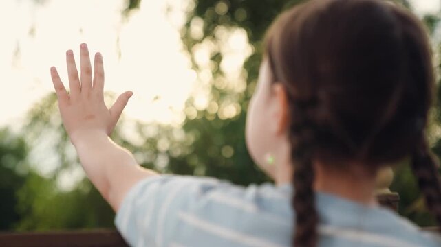 child kid girl catches sun glare with her hand, sun rays through children's fingers, children's bright dream, happy family, child kid girl bright sunny summer, child kid girl children's dream,