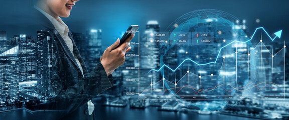 A business professional stands before a vibrant city skyline, engaging with smartphone technology while surrounded by holographic financial data and graphs at night. Scalp © InfiniteFlow