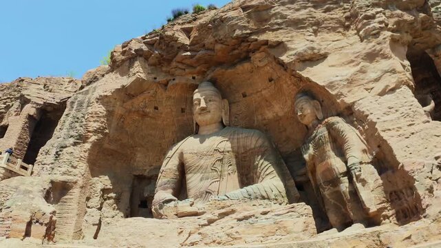 Yungang, China - May 9 2026: Majestic Buddha statue in the Yungang Grottoes, embodying spiritual serenity, monumental artistry, and the rich heritage of ancient Chinese Buddhist culture