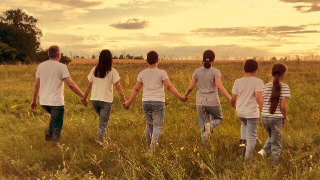 child parent, mother, father nature holding hand, happy family dream, Sunset horizon walk, Linking hands in love, Joyful family field, Rural wildflowers, Outdoor togetherness, Childhood and parenthood