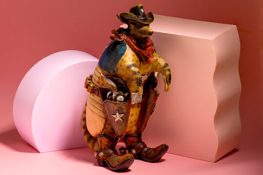 Novelty Resin Armadillo Sheriff Figurine on Pink Background &mdash; Texas Souvenir Folk Art