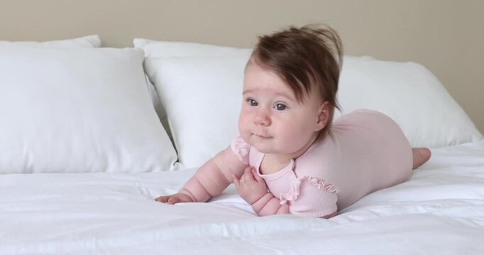 Cute little baby crawling on bed at home
