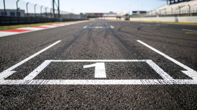 Grid, PolePosition, low-angle close-up Pole position number one sign on asphalt race track, arrival first win start concept, motor sports symbols.