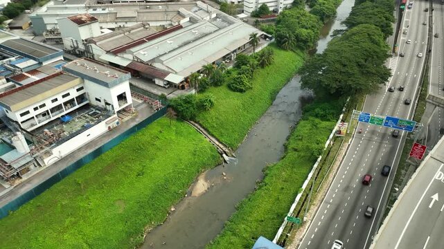 Aerial View of Urban River Beside Highway and Industry