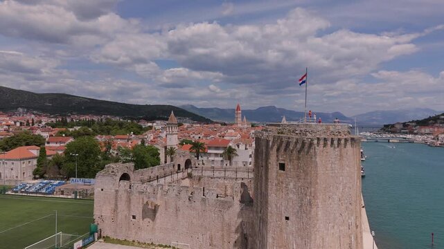 Medieval fortress and football field behind in old town of Trogir aerial Croatia