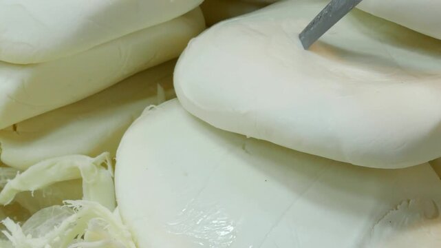Fresh organic mozzarella cheese blocks displayed at local market for culinary use and food preparation