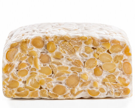 Close-up of fresh raw tempeh on white background