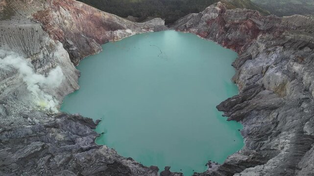 High angle view of the acid crater lake in Kawah Ijen volcano located in East Java, indonesia. The lake is recognised as the largest highly acidic crater lake in the world.