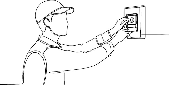Construction worker using security keypad on wall.