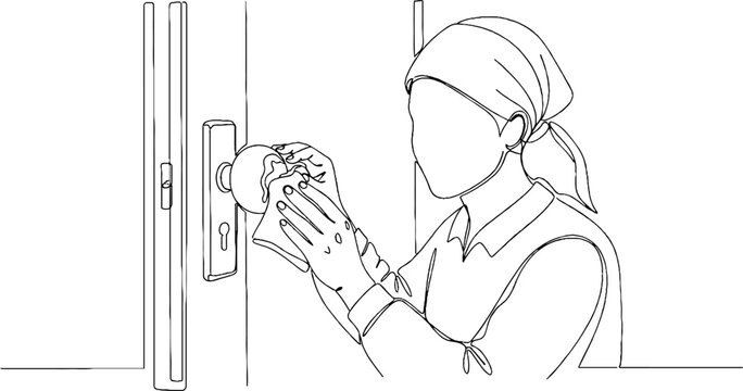 Woman wearing gloves cleaning a doorknob with a cloth.