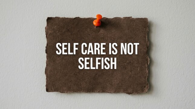Dark brown rustic paper note pinned to a wall featuring an important self care message