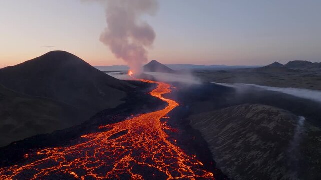 Aerial view of glowing lava flowing from a volcanic eruption across the rugged terrain of the Reykjanes Peninsula, Iceland.