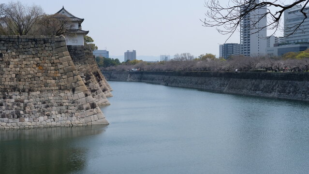 Historic Osaka Castle Moat and Ancient Stone Walls with Modern City Skyline, Japan