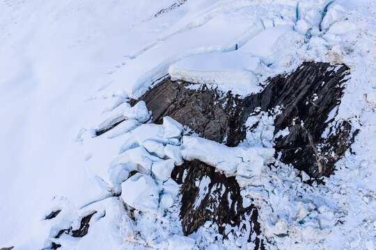 Aerial View Of Glacier Ice And Rocky Crevasse On Mountain Slope In British Columbia, Canada