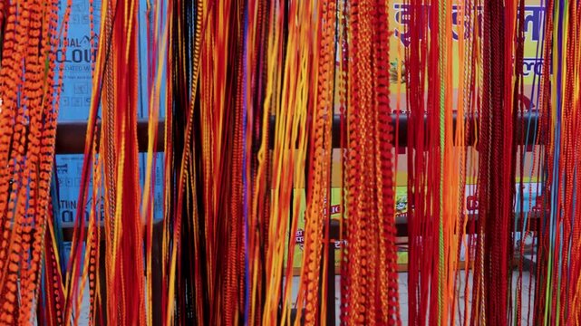 Vibrant Hindu Prayer Threads Hanging at Pilgrimage Souvenir Shop in Ayodhya