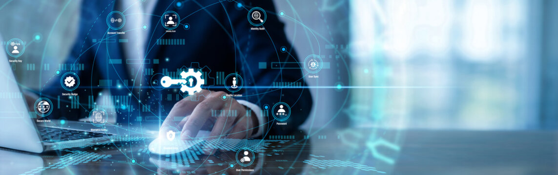 Security analyst working on laptop using Access Management network systems to verify user identities. Safeguarding sensitive data against breaches by enforcing strict login protocols daily.