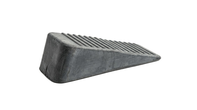 Low black rubber wheel chock wedge with grooved grip isolated on white, heavy duty stopper for vehicles, trailers, carts, and garage safety pads!

